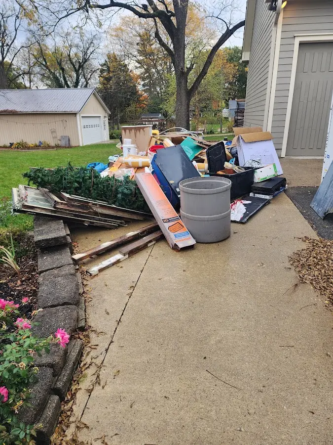 Dumpster being loaded with debris for Estate Cleanout Dumpster Rental in West Brandywine